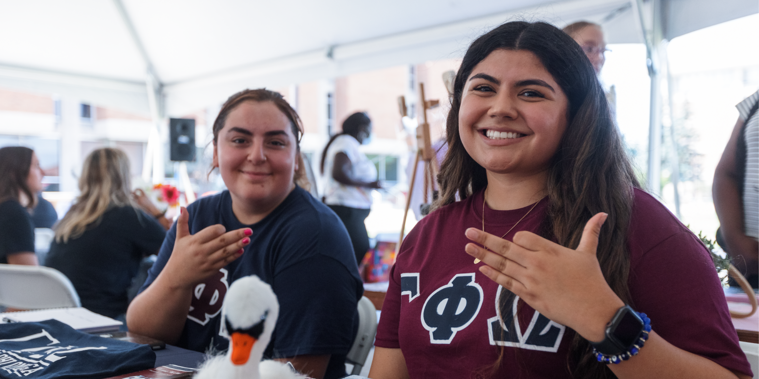 Two student organization members at their info table.