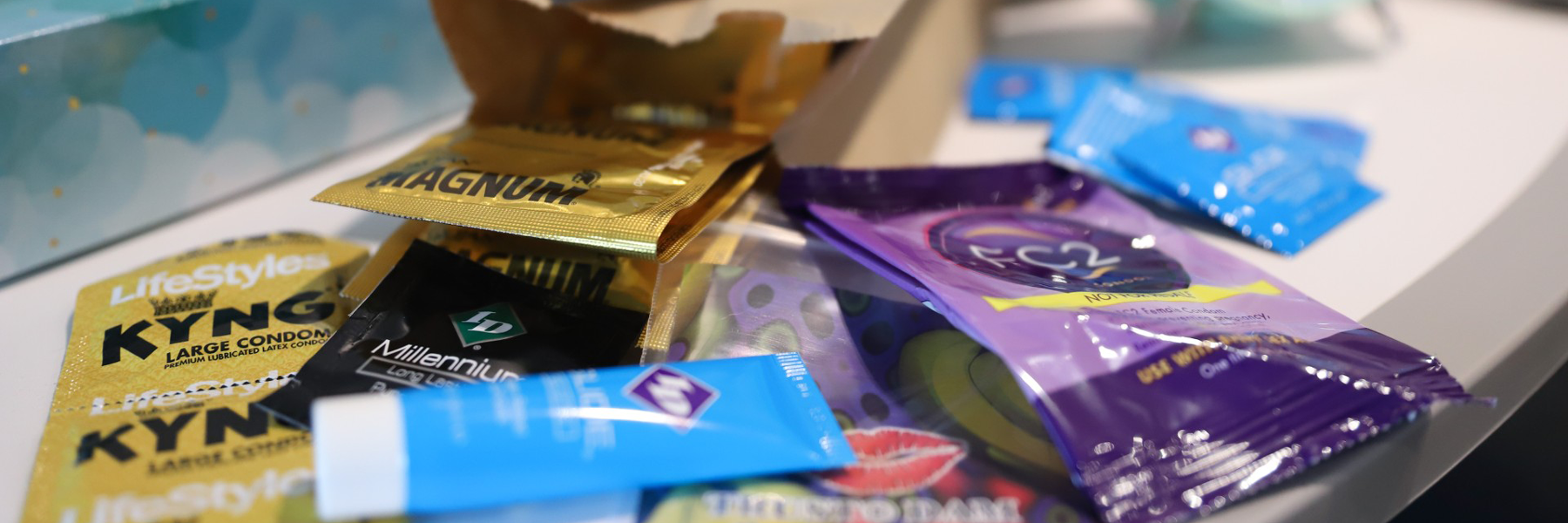 A pile of condoms on a counter.