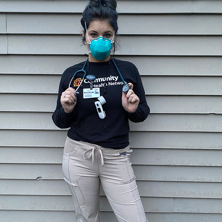 Madison Mick poses for a photo in her mask during a shift working at Community Health Network