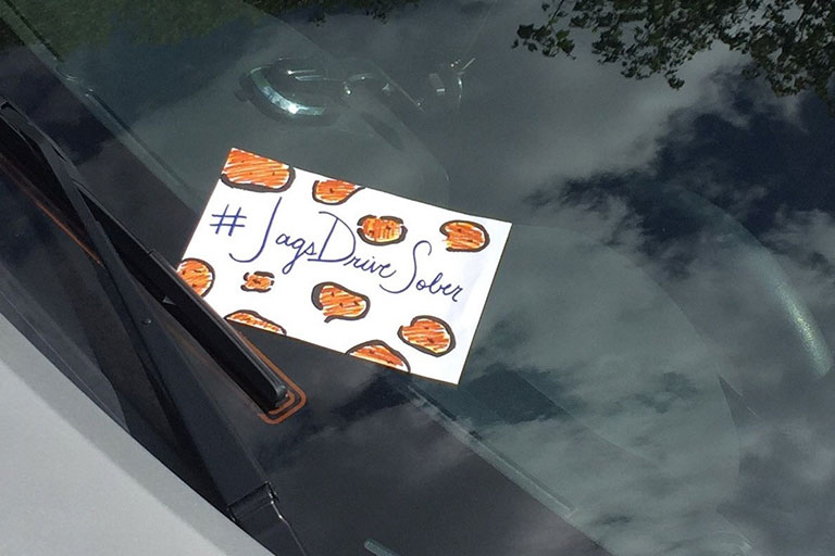 Jags Drive Sober sign on a windshield